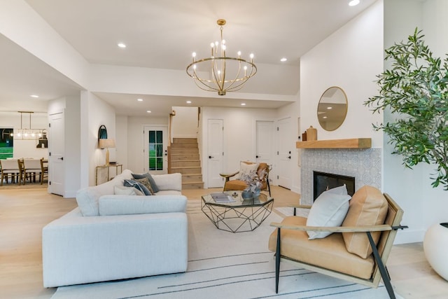 3104 Mistyglen Cir, Austin, TX 78746 - living area with a chandelier, stairway, recessed lighting, a glass covered fireplace, and light wood-style flooring