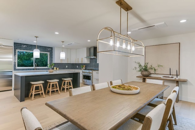 3104 Mistyglen Cir, Austin, TX 78746 - dining area featuring light wood finished floors and recessed lighting