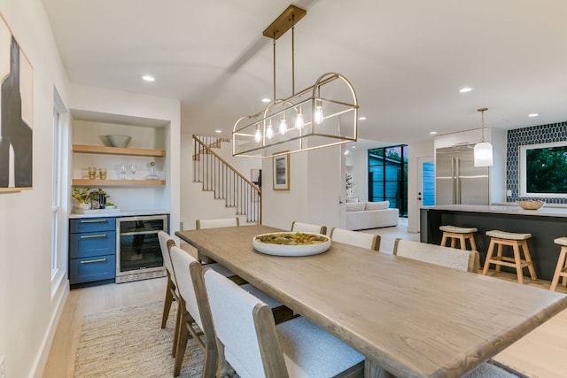 3104 Mistyglen Cir, Austin, TX 78746 - dining area with beverage cooler, a bar, stairs, light wood-style floors, and recessed lighting