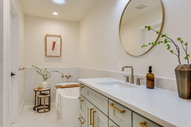 3104 Mistyglen Cir, Austin, TX 78746 - full bathroom featuring vanity, a soaking tub, marble finish floors, wainscoting, and recessed lighting