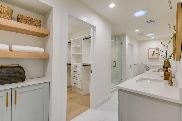 3104 Mistyglen Cir, Austin, TX 78746 - full bathroom with a marble finish shower, double vanity, a spacious closet, recessed lighting, and marble look tiles