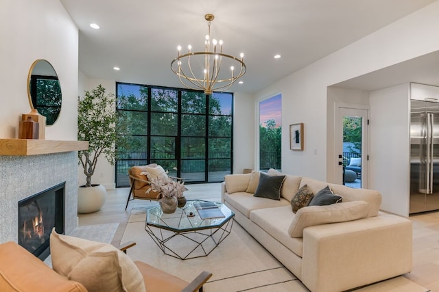 3104 Mistyglen Cir, Austin, TX 78746 - living area with recessed lighting, floor to ceiling windows, a chandelier, light wood-style flooring, and a glass covered fireplace