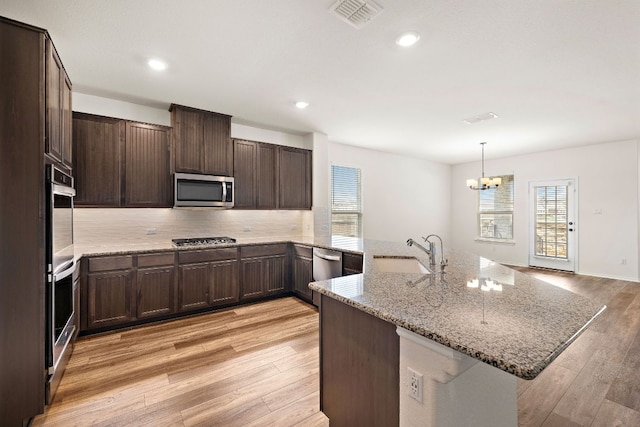 4669 Padula Dr, Round Rock, TX 78665 - kitchen with stainless steel appliances, plenty of natural light, a chandelier, light wood-style flooring, and recessed lighting