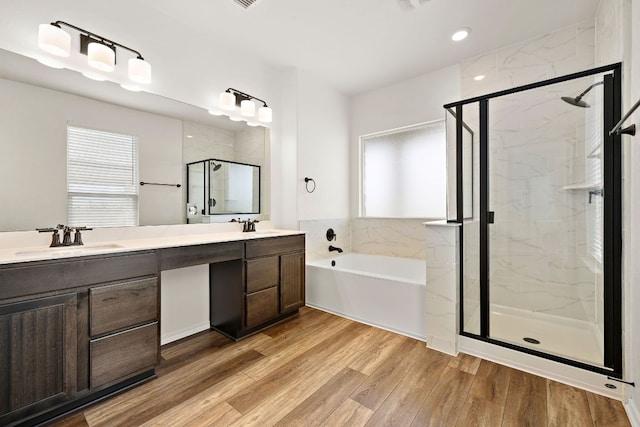 4669 Padula Dr, Round Rock, TX 78665 - full bath with a bath, a stall shower, double vanity, wood finished floors, and plenty of natural light