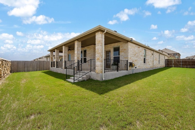 4669 Padula Dr, Round Rock, TX 78665 - rear view of property featuring stone siding and a fenced backyard
