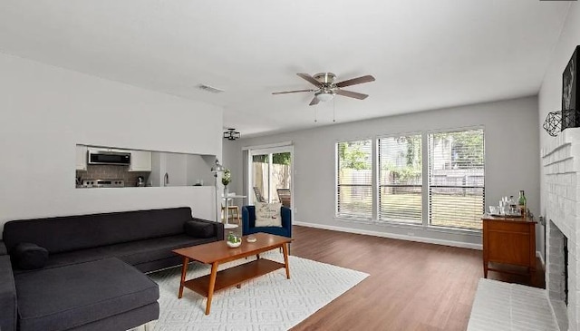 2604 Alcott Ln Unit A & B, Austin, TX 78748 - living room with a ceiling fan, a brick fireplace, and wood finished floors