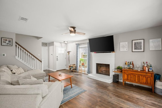 2604 Alcott Ln Unit A & B, Austin, TX 78748 - living room featuring a ceiling fan, stairway, wood finished floors, and a brick fireplace