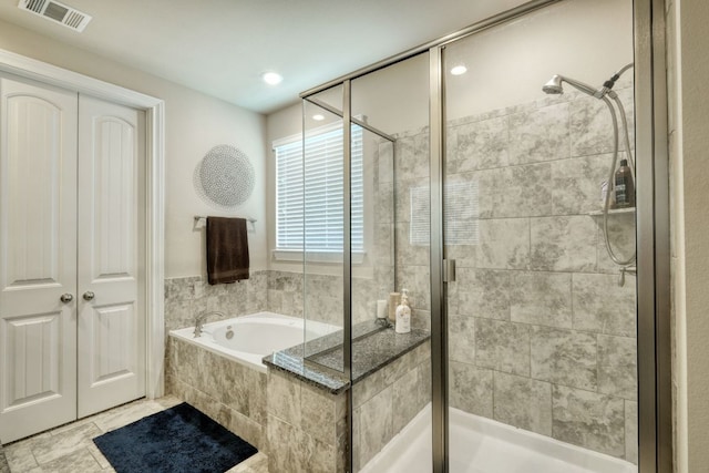 2336 Centennial Loop, Round Rock, TX 78665 - bathroom featuring a bath, a stall shower, and recessed lighting