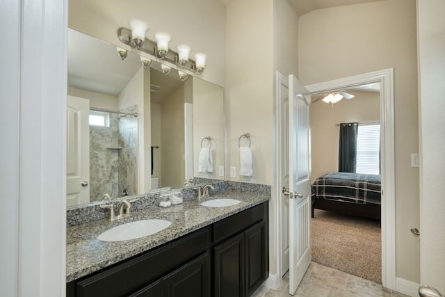 2336 Centennial Loop, Round Rock, TX 78665 - ensuite bathroom featuring a tile shower, double vanity, healthy amount of natural light, and tile patterned flooring