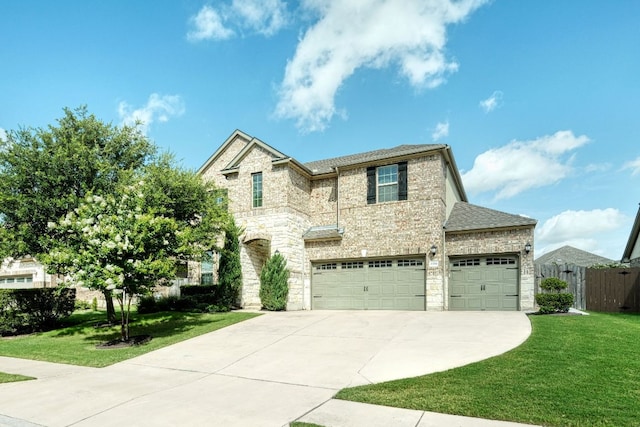 2336 Centennial Loop, Round Rock, TX 78665 - view of front of home with stone siding, driveway, a garage, and roof with shingles