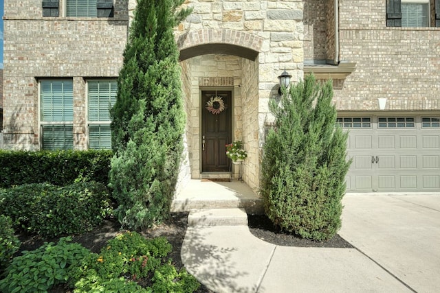 2336 Centennial Loop, Round Rock, TX 78665 - entrance to property featuring a garage, stone siding, and concrete driveway