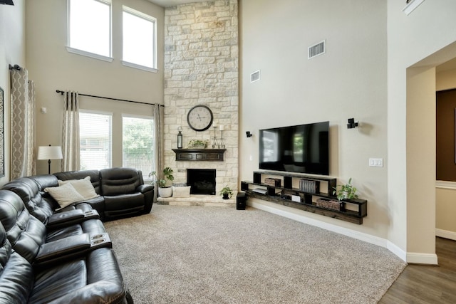 2336 Centennial Loop, Round Rock, TX 78665 - living room with a towering ceiling, a stone fireplace, and wood finished floors