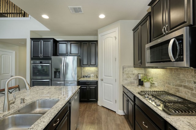 2336 Centennial Loop, Round Rock, TX 78665 - kitchen featuring stainless steel appliances, dark wood-type flooring, recessed lighting, backsplash, and light stone counters