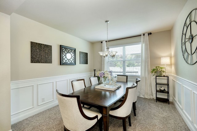 2336 Centennial Loop, Round Rock, TX 78665 - dining area with a decorative wall, a chandelier, light carpet, and wainscoting