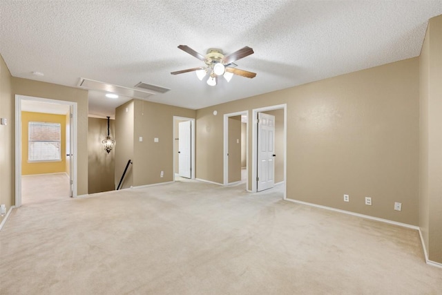 16504 Jadestone Dr, Leander, TX 78641 - empty room featuring attic access, a ceiling fan, a textured ceiling, and light carpet