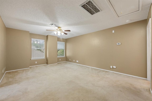 16504 Jadestone Dr, Leander, TX 78641 - empty room featuring attic access, ceiling fan, light carpet, and a textured ceiling