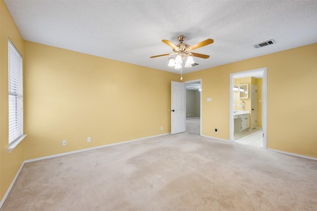 16504 Jadestone Dr, Leander, TX 78641 - unfurnished bedroom with light colored carpet, multiple windows, and ensuite bath