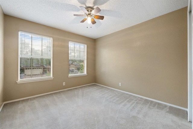 16504 Jadestone Dr, Leander, TX 78641 - spare room featuring light carpet, a ceiling fan, and a textured ceiling