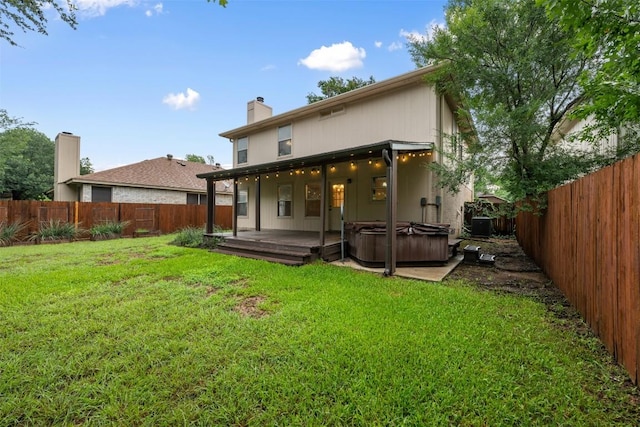 16504 Jadestone Dr, Leander, TX 78641 - rear view of property with a hot tub, a fenced backyard, and a chimney