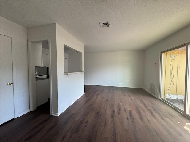 4908 W Gate Blvd, Austin, TX 78745 - spare room featuring dark wood-type flooring and a textured ceiling