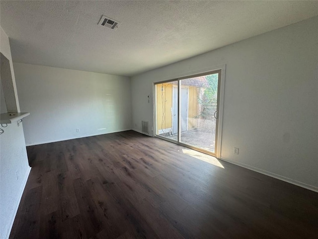 4908 W Gate Blvd, Austin, TX 78745 - spare room with dark wood-type flooring and a textured ceiling