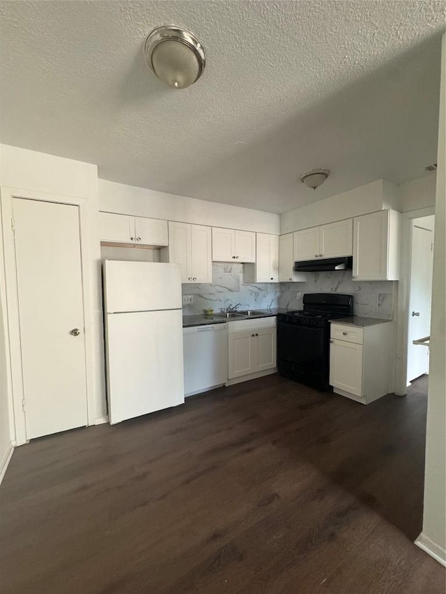 4908 W Gate Blvd, Austin, TX 78745 - kitchen featuring white appliances, under cabinet range hood, white cabinetry, dark wood-style floors, and a textured ceiling