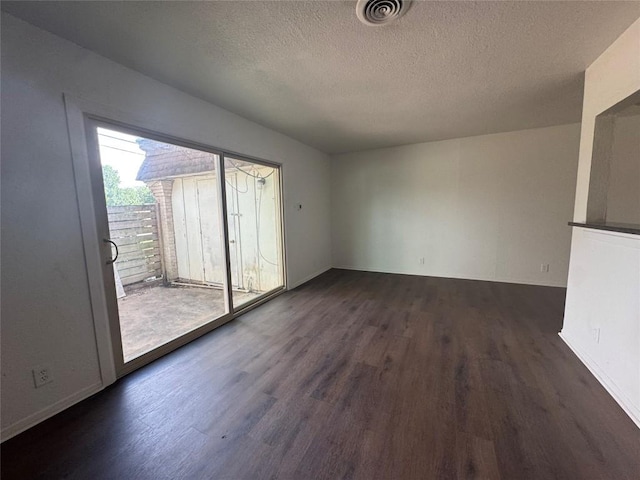4908 W Gate Blvd, Austin, TX 78745 - empty room with dark wood-type flooring and a textured ceiling