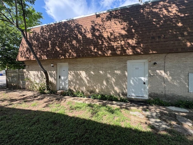 4908 W Gate Blvd, Austin, TX 78745 - back of property featuring brick siding, mansard roof, and a shingled roof
