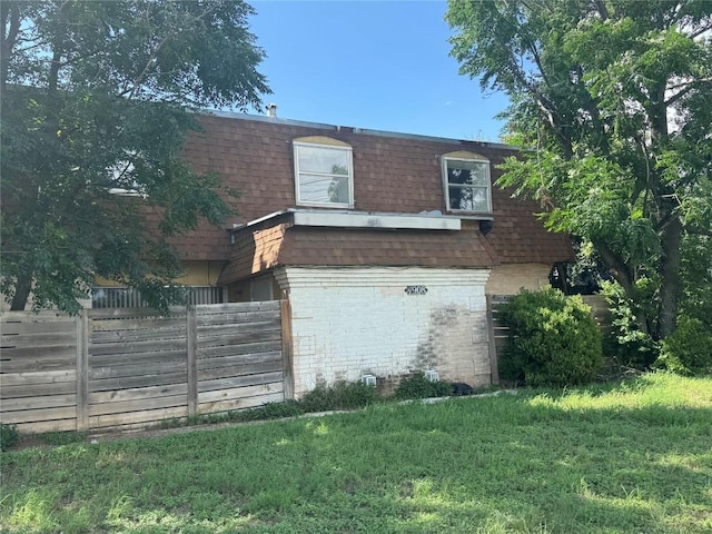 4908 W Gate Blvd, Austin, TX 78745 - view of property exterior featuring mansard roof, a shingled roof, and brick siding