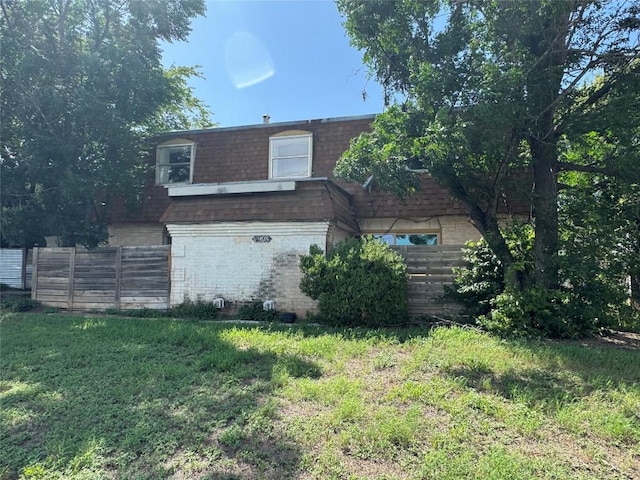 4908 W Gate Blvd, Austin, TX 78745 - view of front of property with mansard roof, brick siding, and roof with shingles