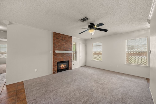 1625 Sylvia Ct, Round Rock, TX 78681 - unfurnished living room with a ceiling fan, a fireplace, and a textured ceiling