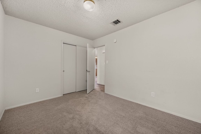 1625 Sylvia Ct, Round Rock, TX 78681 - unfurnished bedroom with carpet flooring, a closet, and a textured ceiling