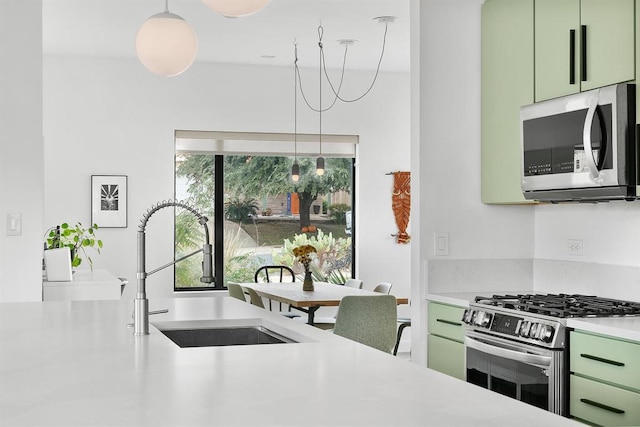 5725 Toscana Ave, Austin, TX 78724 - kitchen featuring stainless steel appliances, green cabinets, and light countertops