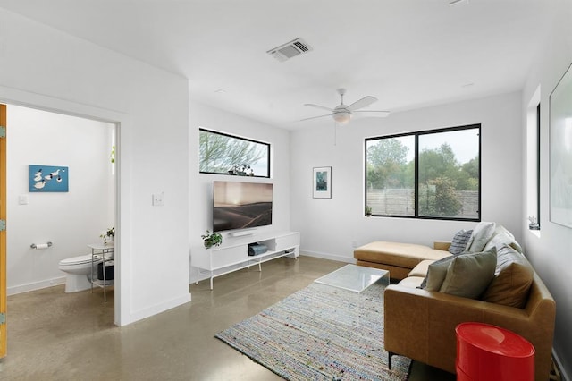 5725 Toscana Ave, Austin, TX 78724 - living room with concrete floors and ceiling fan