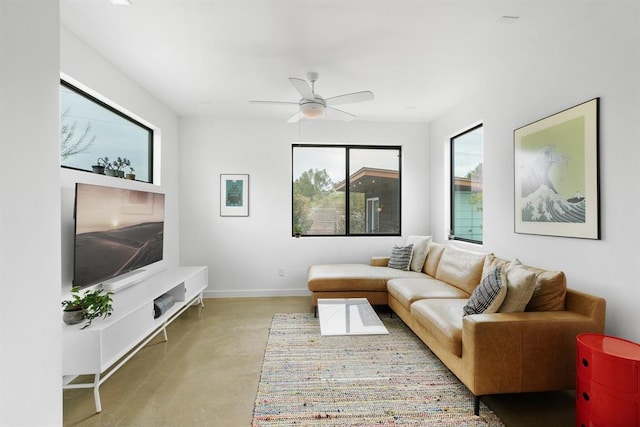 5725 Toscana Ave, Austin, TX 78724 - living room featuring plenty of natural light, a ceiling fan, and concrete flooring