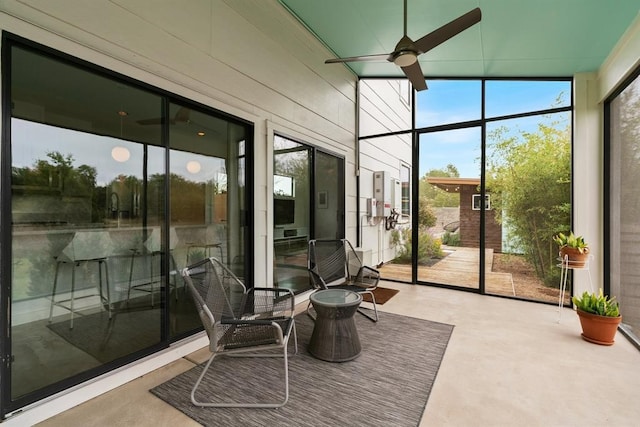 5725 Toscana Ave, Austin, TX 78724 - sunroom / solarium with a ceiling fan, concrete flooring, and a wall of windows