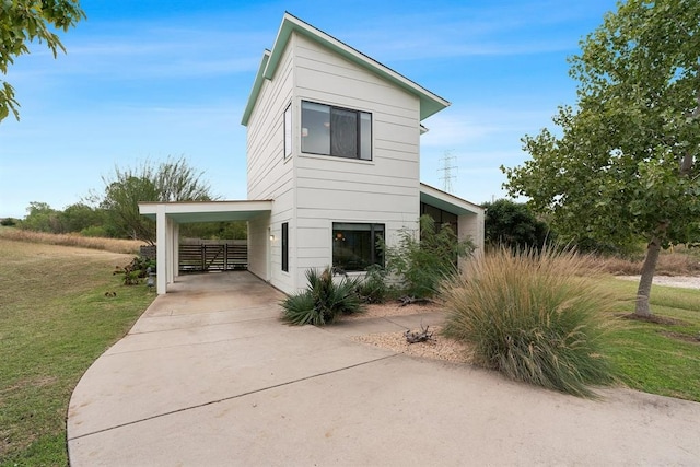 5725 Toscana Ave, Austin, TX 78724 - view of side of property featuring an attached carport, a yard, and driveway