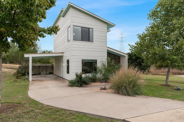 5725 Toscana Ave, Austin, TX 78724 - view of side of home with a lawn, concrete driveway, and an attached carport