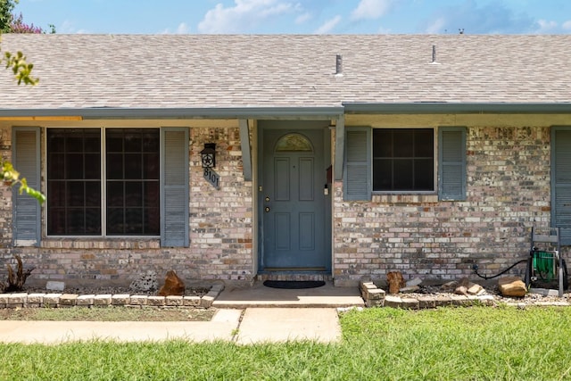 8101 Parkdale Dr, Austin, TX 78757 - entrance to property featuring roof with shingles and brick siding