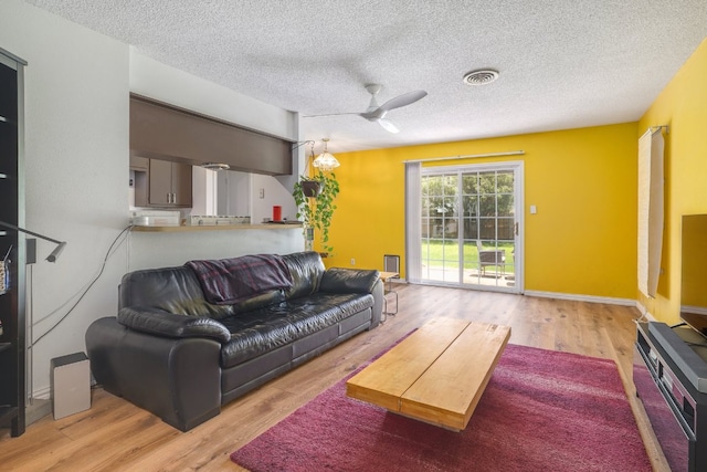 8101 Parkdale Dr, Austin, TX 78757 - living room with a textured ceiling, wood finished floors, and ceiling fan