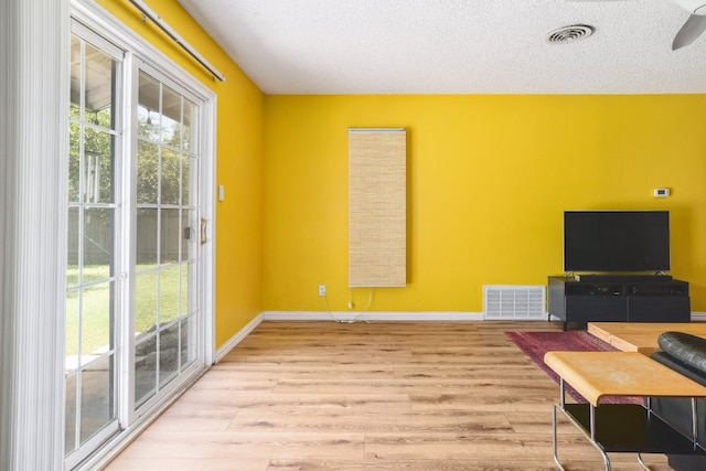 8101 Parkdale Dr, Austin, TX 78757 - home office featuring wood finished floors, a ceiling fan, and a textured ceiling