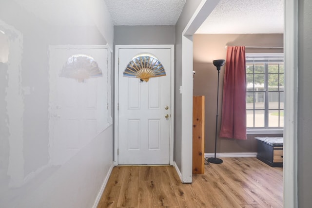 8101 Parkdale Dr, Austin, TX 78757 - foyer with light wood-type flooring and a textured ceiling