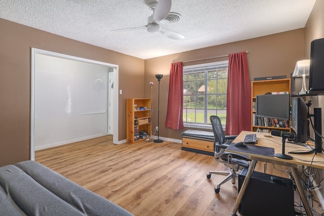 8101 Parkdale Dr, Austin, TX 78757 - office area with a ceiling fan, light wood-style flooring, and a textured ceiling