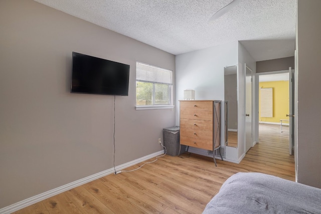8101 Parkdale Dr, Austin, TX 78757 - bedroom with light wood-type flooring and a textured ceiling