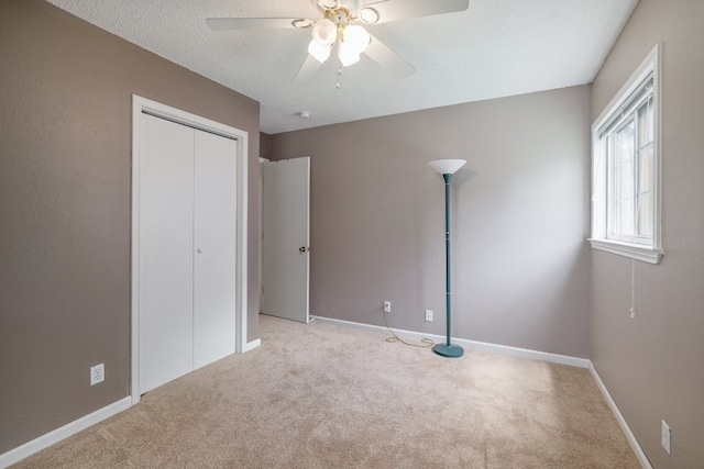8101 Parkdale Dr, Austin, TX 78757 - unfurnished bedroom featuring carpet flooring, a closet, ceiling fan, and a textured ceiling