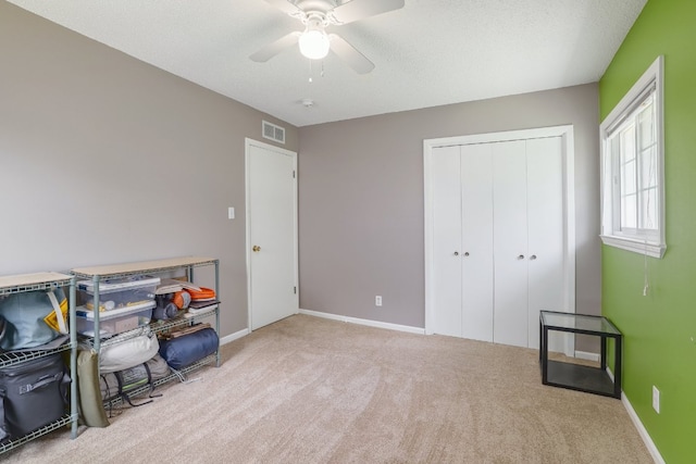 8101 Parkdale Dr, Austin, TX 78757 - carpeted bedroom featuring a closet, a ceiling fan, and a textured ceiling