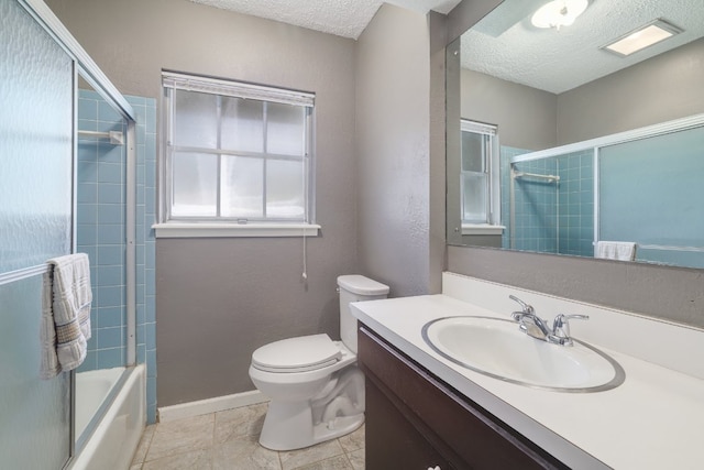 8101 Parkdale Dr, Austin, TX 78757 - bathroom featuring a textured ceiling, vanity, and enclosed tub / shower combo