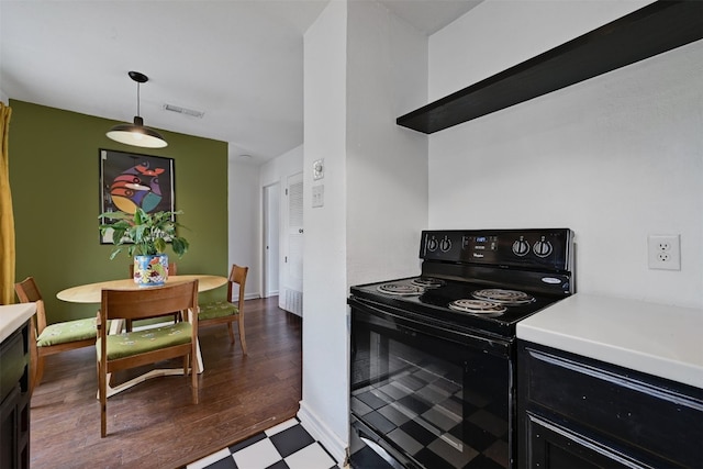 3902 Peterson Ave Unit 203, Austin, TX 78756 - kitchen featuring black range with electric cooktop, light countertops, dark flooring, and dark cabinetry