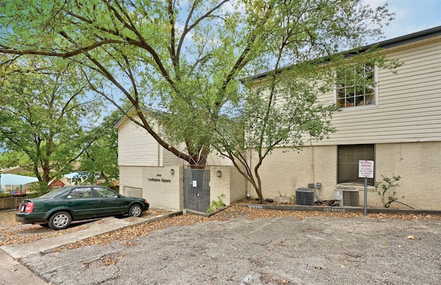 3902 Peterson Ave Unit 203, Austin, TX 78756 - view of property exterior with brick siding, a garage, and driveway