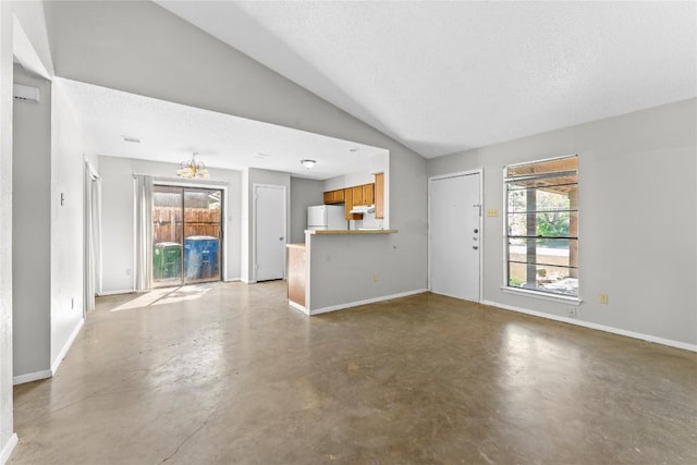 6201 Berkett Cv, Austin, TX 78745 - unfurnished living room featuring concrete flooring, vaulted ceiling, and a chandelier